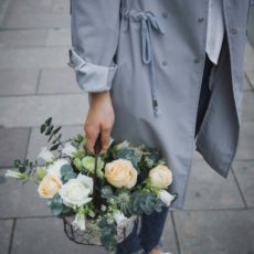woman holding basket of flowers