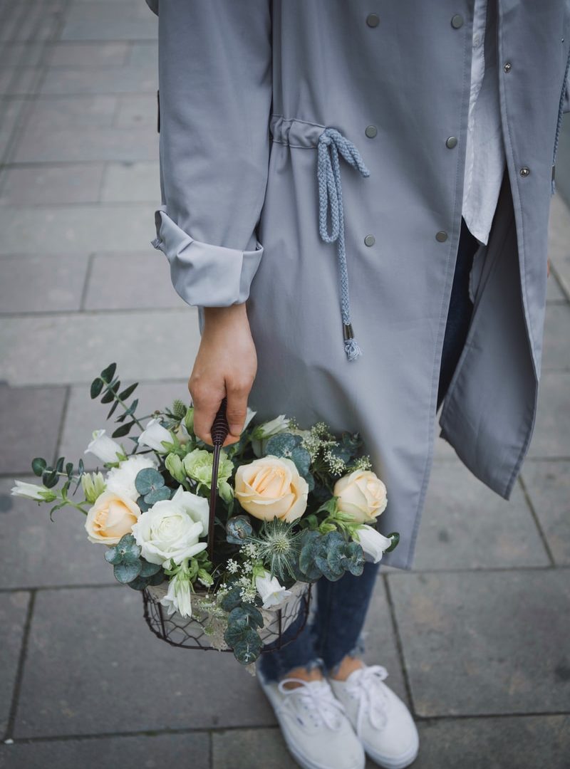 woman holding basket of flowers